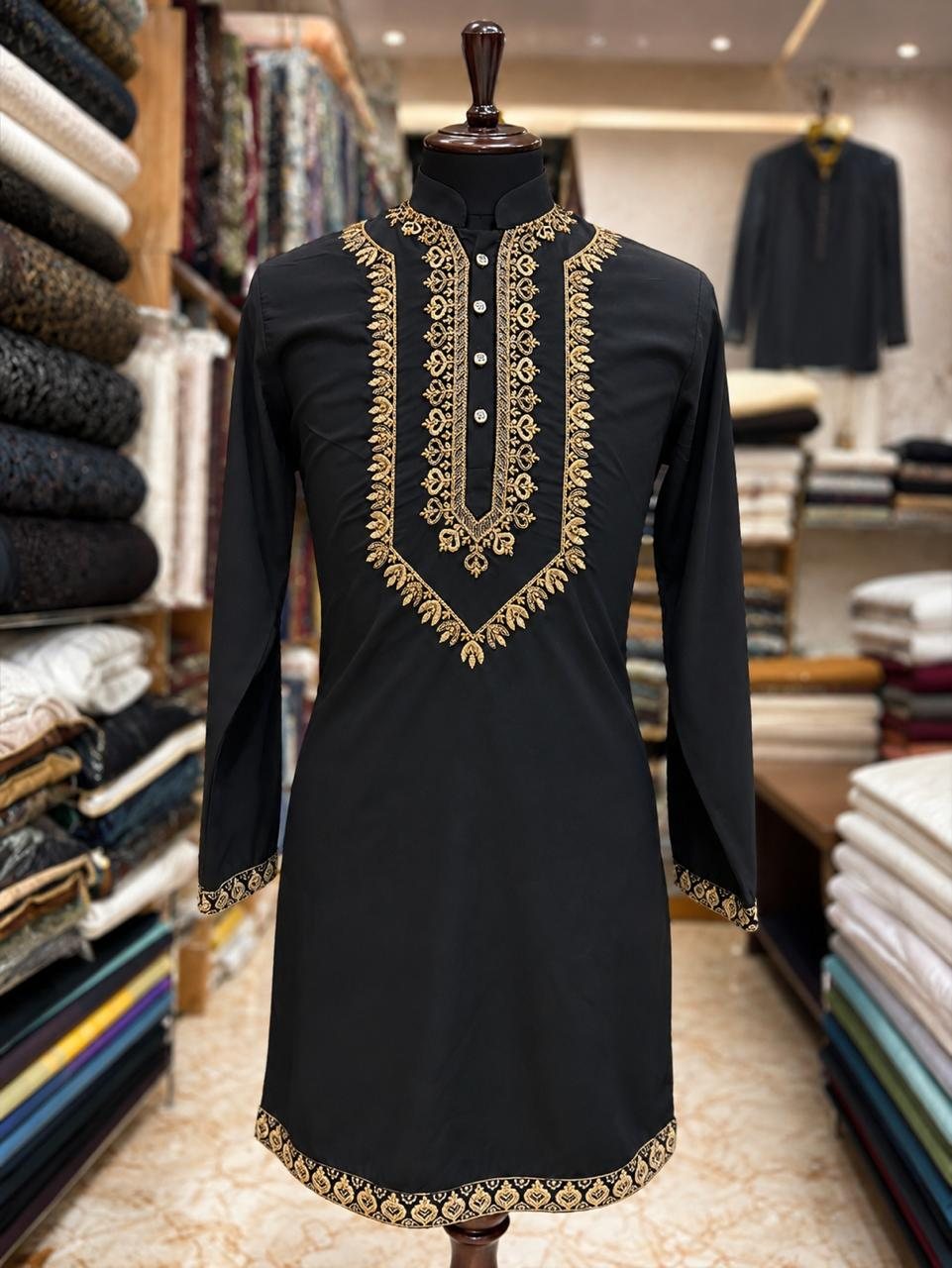 A black kurta with gold embroidery down the placket