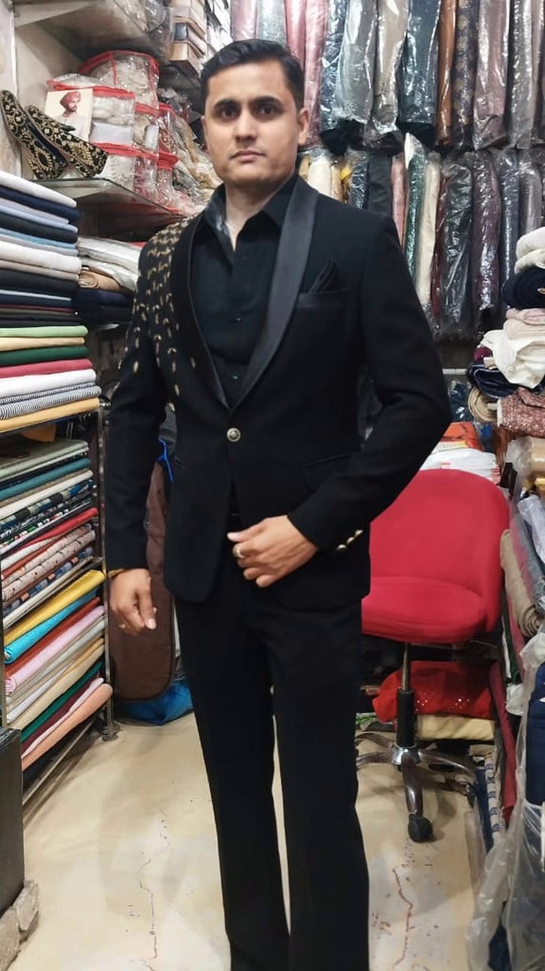 A man in a black tuxedo with a satin shawl lapel